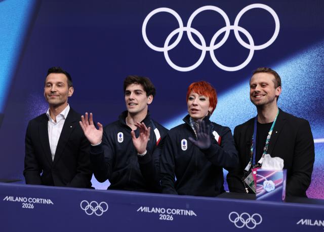 (260212) -- MILAN, Feb. 12, 2026 (Xinhua) -- Evgeniia Lopareva and Geoffrey Brissaud of France react as they wait for the scores during the free dance competition of figure skating ice dance at the Milan-Cortina 2026 Olympic Winter Games in Milan, Italy, Feb. 11, 2026. (Xinhua/Chen Yichen)