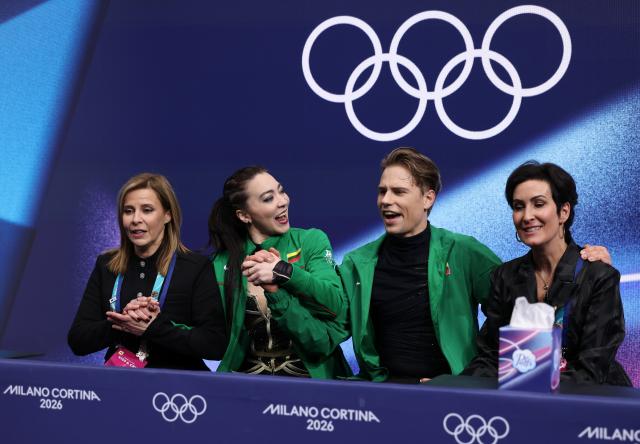 (260212) -- MILAN, Feb. 12, 2026 (Xinhua) -- Allison Reed and Saulius Ambrulevicius of Lithuania react as they wait for the scores during the free dance competition of figure skating ice dance at the Milan-Cortina 2026 Olympic Winter Games in Milan, Italy, Feb. 11, 2026. (Xinhua/Chen Yichen)