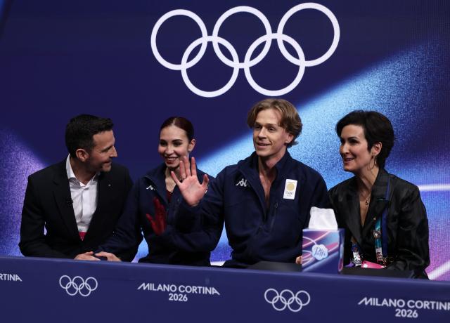 (260212) -- MILAN, Feb. 12, 2026 (Xinhua) -- Diana Davis and Gleb Smolkin of Georgia react as they wait for the scores during the free dance competition of figure skating ice dance at the Milan-Cortina 2026 Olympic Winter Games in Milan, Italy, Feb. 11, 2026. (Xinhua/Chen Yichen)
