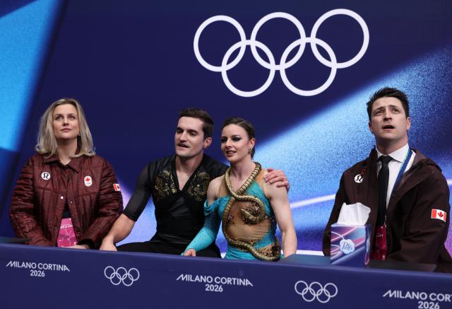 (260212) -- MILAN, Feb. 12, 2026 (Xinhua) -- Marie-Jade Lauriault and Romain le Gac of Canada reactr as they wait for the scores during the free dance competition of figure skating ice dance at the Milan-Cortina 2026 Olympic Winter Games in Milan, Italy, Feb. 11, 2026. (Xinhua/Chen Yichen)