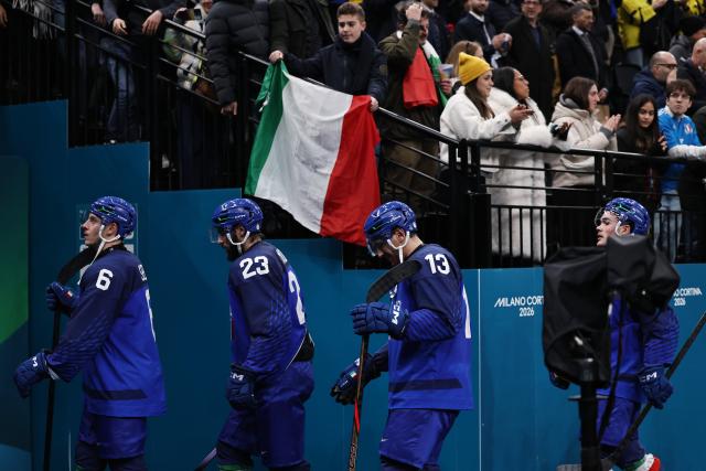(260212) -- MILAN, Feb. 12, 2026 (Xinhua) -- Players of Italy leave the court after the ice hockey men's preliminary round group B match between Italy and Sweden at the Milan-Cortina 2026 Olympic Winter Games in Milan, Italy, Feb. 11, 2026. (Xinhua/Wang Kaiyan)