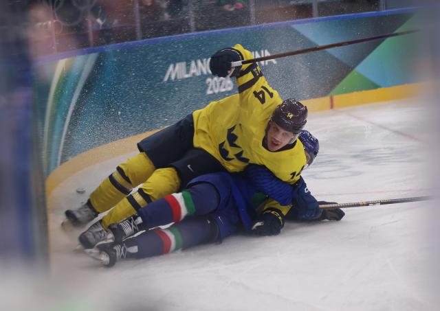 (260212) -- MILAN, Feb. 12, 2026 (Xinhua) -- Joel Eriksson Ek (top) of Sweden competes during the ice hockey men's preliminary round group B match between Italy and Sweden at the Milan-Cortina 2026 Olympic Winter Games in Milan, Italy, Feb. 11, 2026. (Xinhua/Wang Kaiyan)