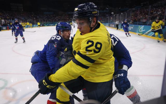 (260212) -- MILAN, Feb. 12, 2026 (Xinhua) -- Pontus Holmberg (C) of Sweden competes during the ice hockey men's preliminary round group B match between Italy and Sweden at the Milan-Cortina 2026 Olympic Winter Games in Milan, Italy, Feb. 11, 2026. (Xinhua/Wang Kaiyan)