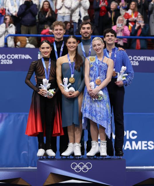 (260212) -- MILAN, Feb. 12, 2026 (Xinhua) -- Silver medalists Madison Chock and Evan Bates of the United States, gold medalists Laurence Fournier Beaudry and Guillaume Cizeron of France and bronze medalists Piper Gilles and Paul Poirier of Canada (L to R) pose on the podium after the free dance competition of figure skating ice dance at the Milan-Cortina 2026 Olympic Winter Games in Milan, Italy, Feb. 11, 2026. (Xinhua/Chen Yichen)