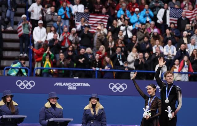 (260212) -- MILAN, Feb. 12, 2026 (Xinhua) -- Silver medalists Madison Chock and Evan Bates of the United States react on the podium after the free dance competition of figure skating ice dance at the Milan-Cortina 2026 Olympic Winter Games in Milan, Italy, Feb. 11, 2026. (Xinhua/Chen Yichen)