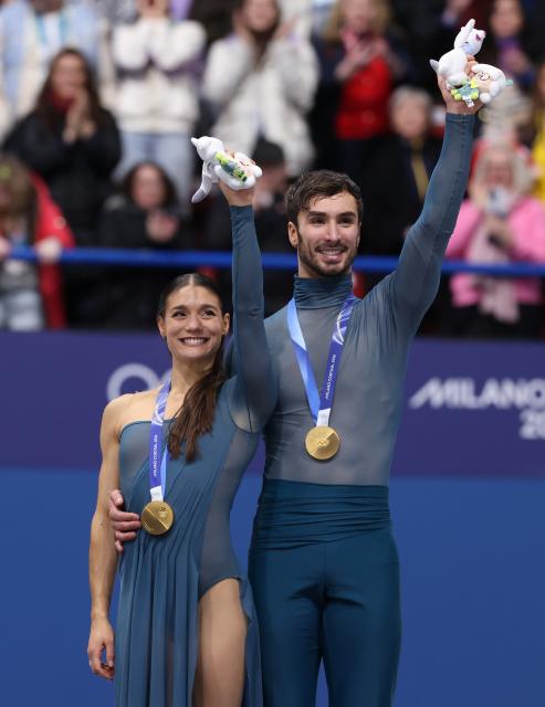 (260212) -- MILAN, Feb. 12, 2026 (Xinhua) -- Gold medalists Laurence Fournier Beaudry and Guillaume Cizeron of France react on the podium after the free dance competition of figure skating ice dance at the Milan-Cortina 2026 Olympic Winter Games in Milan, Italy, Feb. 11, 2026. (Xinhua/Chen Yichen)
