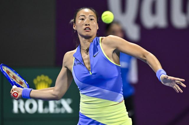(260212) -- DOHA, Feb. 12, 2026 (Xinhua) -- Zheng Qinwen of China hits a return during the women's singles round of 16 match between Zheng Qinwen of China and Elena Rybakina of Kazakhstan at the WTA Qatar Open 2026 tennis tournament in Doha, Qatar, Feb. 11, 2026. (Photo by Nikku/Xinhua)