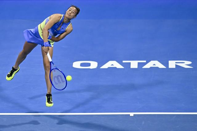 (260212) -- DOHA, Feb. 12, 2026 (Xinhua) -- Zheng Qinwen of China serves during the women's singles round of 16 match between Zheng Qinwen of China and Elena Rybakina of Kazakhstan at the WTA Qatar Open 2026 tennis tournament in Doha, Qatar, Feb. 11, 2026. (Photo by Nikku/Xinhua)