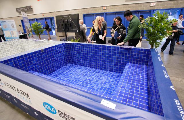 (260212) -- VANCOUVER, Feb. 12, 2026 (Xinhua) -- People look at a fiberglass pool at the BUILDEX 2026 trade show at the Vancouver Convention Center in Vancouver, British Columbia, Canada, on Feb. 11, 2026.
  The BUILDEX 2026 kicked off here on Wednesday. (Photo by Liang Sen/Xinhua)