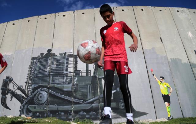 (260212) -- BETHLEHEM, Feb. 12, 2026 (Xinhua) -- A Palestinian child plays football in Bethlehem City in the West Bank, on Feb. 11, 2026. (Photo by Mamoun Wazwaz/Xinhua)