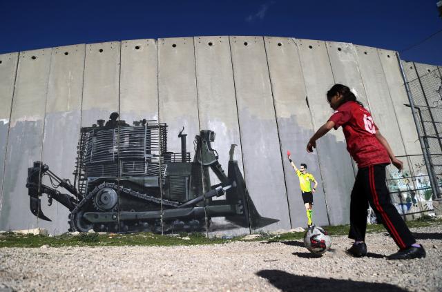 (260212) -- BETHLEHEM, Feb. 12, 2026 (Xinhua) -- A Palestinian child plays football in Bethlehem City in the West Bank, on Feb. 11, 2026. (Photo by Mamoun Wazwaz/Xinhua)