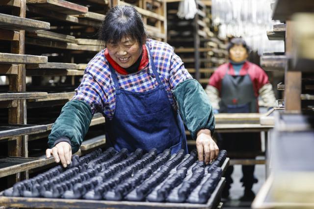 (260212) -- HUANGSHAN, Feb. 12, 2026 (Xinhua) -- A craftswoman airs Hui ink sticks inspired by the Chinese zodiac Year of the Horse at an ink workshop in Shexian County, east China's Anhui Province, Feb. 11, 2026.
  Delicate Hui ink sticks inspired by the Chinese zodiac Year of the Horse delight the eyes, making the millennium-old ink-making craftsmanship shine again.
  Hui ink sticks are mainly crafted in east China's Anhui Province, hence earning the moniker "Hui" ink, as the region was originally under the jurisdiction of Huizhou in ancient China. (Photo by Shi Yalei/Xinhua)