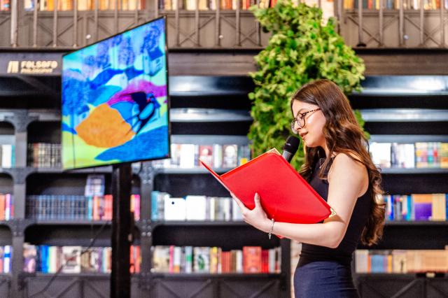 (260212) -- BAKU, Feb. 12, 2026 (Xinhua) -- A student from the Confucius Institute at Azerbaijan University of Languages performs Chinese poetry recitation during a Chinese New Year cultural event at Baku Book Center in Baku, Azerbaijan, Feb. 11, 2026. The Confucius Institute at Azerbaijan University of Languages hosted a Chinese New Year cultural event here on Wednesday. Over 80 local audience joined students from the institute as well as representatives of Chinese-funded enterprises to enjoy performances including classical Chinese poetry recitations, classic Chinese songs, Chinese folk-style dances, and Peking Opera excerpts. (Xinhua/Chen Junfeng)