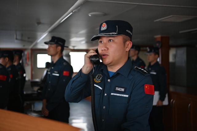 (260212) -- SOUTH CHINA SEA, Feb. 12, 2026 (Xinhua) -- A law enforcer aboard the China Coast Guard (CCG) vessel Wanshan issues warning messages during a patrol mission in the territorial waters of China's Huangyan Dao, Feb. 6, 2026. (Photo by Zhai Yifan/Xinhua)
