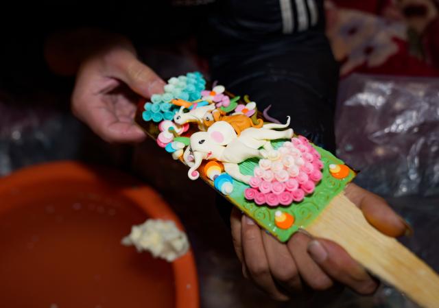 (260212) -- LHASA, Feb. 12, 2026 (Xinhua) -- A craftsman makes a butter sculpture in Lhasa, southwest China's Xizang Autonomous Region, Feb. 12, 2026. Butter sculptures in vivid shapes of trees, flowers, birds, stars, etc., are gradually gaining popularity in the markets across the city ahead of the Tibetan New Year.
   These sculptures, made skillfully with colored butter, convey people's good wishes for the New Year. (Xinhua/Tenzin Nyida)