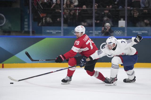 (260212) -- MILAN, Feb. 12, 2026 (Xinhua) -- Calvin Thurkauf (L) of Switzerland competes with Pierre Crinon of France during the ice hockey men's preliminary round group A match between Switzerland and France at the Milan-Cortina 2026 Olympic Winter Games in Milan, Italy, Feb. 12, 2026. (Xinhua/Tao Xiyi)