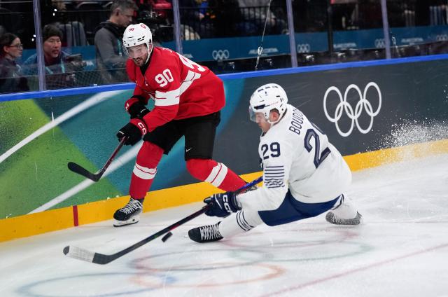 (260212) -- MILAN, Feb. 12, 2026 (Xinhua) -- Roman Josi (L) of Switzerland competes with Louis Boudon of France during the ice hockey men's preliminary round group A match between Switzerland and France at the Milan-Cortina 2026 Olympic Winter Games in Milan, Italy, Feb. 12, 2026. (Xinhua/Tao Xiyi)