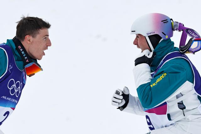 (260212) -- LIVIGNO, Feb. 12, 2026 (Xinhua) -- Cooper Woods (R) of Australia and Matt Graham of Australia react after the freestyle skiing men's moguls final at the Milan-Cortina 2026 Olympic Winter Games in Livigno, Italy, Feb. 12, 2026. (Xinhua/Wang Peng)