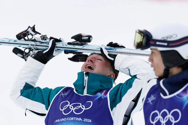 (260212) -- LIVIGNO, Feb. 12, 2026 (Xinhua) -- Cooper Woods (L) of Australia reacts after the freestyle skiing men's moguls final at the Milan-Cortina 2026 Olympic Winter Games in Livigno, Italy, Feb. 12, 2026. (Xinhua/Wang Peng)