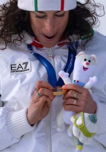 (260212) -- CORTINA D'AMPEZZO, Feb. 12, 2026 (Xinhua) -- Gold medalist Federica Brignone of Italy looks at her medal during the awarding ceremony of the alpine skiing women's Super-G at the 2026 Milan-Cortina Winter Olympics in Cortina, Italy, Feb. 12, 2026. (Xinhua/Fei Maohua)