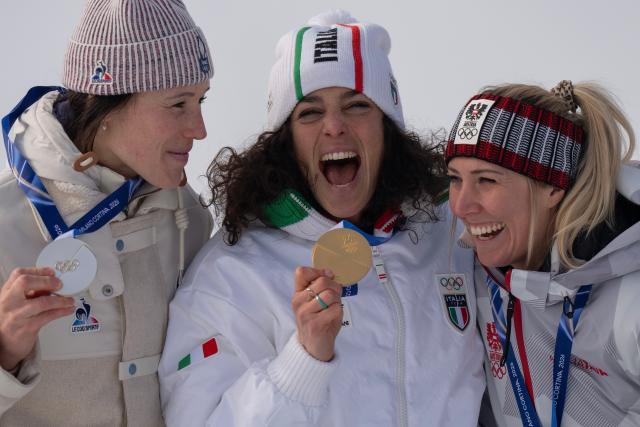 (260212) -- CORTINA D'AMPEZZO, Feb. 12, 2026 (Xinhua) -- Gold medalist Federica Brignone (C) of Italy, silver medalist Romane Miradoli (L) of France and bronze medalist Cornelia Huetter of Austria celebrate during the awarding ceremony of the alpine skiing women's Super-G at the 2026 Milan-Cortina Winter Olympics in Cortina, Italy, Feb. 12, 2026. (Xinhua/Fei Maohua)