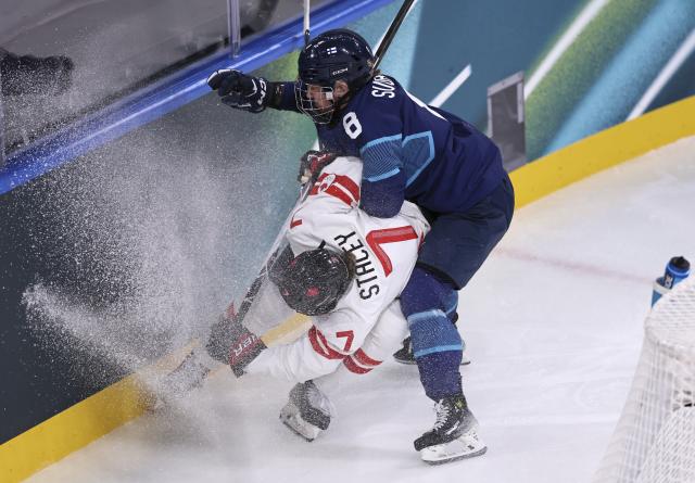 (260212) -- MILAN, Feb. 12, 2026 (Xinhua) -- Laura Stacey (L) of Canada vies the puck with Elli Suoranta of Finland during the ice hockey women's preliminary round group A match between Finland and Canada at the Milan-Cortina 2026 Olympic Winter Games in Milan, Italy, Feb. 12, 2026. (Xinhua/Wang Kaiyan)