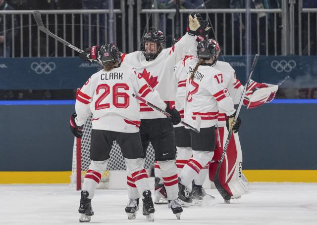 (260212) -- MILAN, Feb. 12, 2026 (Xinhua) -- Players of Canada celebrate scoring during the ice hockey women's preliminary round group A match between Finland and Canada at the Milan-Cortina 2026 Olympic Winter Games in Milan, Italy, Feb. 12, 2026. (Xinhua/Sun Fei)