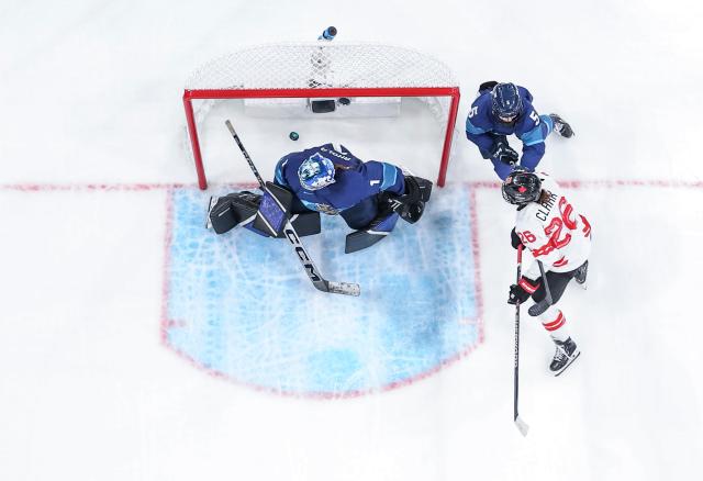 (260212) -- MILAN, Feb. 12, 2026 (Xinhua) -- Emily Clark (1st R) of Canada scores during the ice hockey women's preliminary round group A match between Finland and Canada at the Milan-Cortina 2026 Olympic Winter Games in Milan, Italy, Feb. 12, 2026. (Xinhua/Sun Fei)