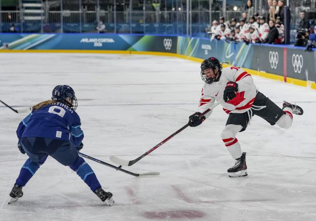 (260212) -- MILAN, Feb. 12, 2026 (Xinhua) -- Sarah Fillier (R) of Canada competes during the ice hockey women's preliminary round group A match between Finland and Canada at the Milan-Cortina 2026 Olympic Winter Games in Milan, Italy, Feb. 12, 2026. (Xinhua/Sun Fei)