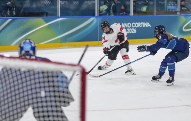 (260212) -- MILAN, Feb. 12, 2026 (Xinhua) -- Renata Fast (C) of Canada shoots during the ice hockey women's preliminary round group A match between Finland and Canada at the Milan-Cortina 2026 Olympic Winter Games in Milan, Italy, Feb. 12, 2026. (Xinhua/Sun Fei)