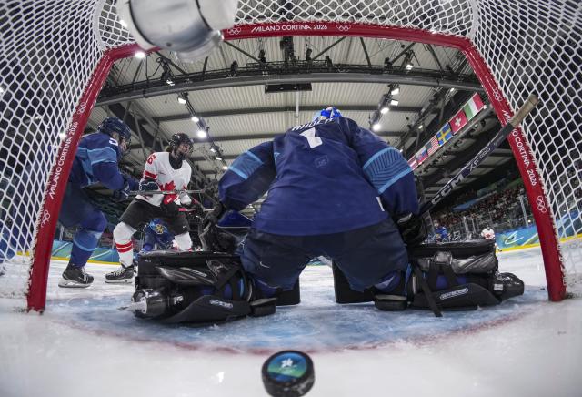 (260212) -- MILAN, Feb. 12, 2026 (Xinhua) -- Goalkeeper Sanni Ahola of Finland fails to save the puck during the ice hockey women's preliminary round group A match between Finland and Canada at the Milan-Cortina 2026 Olympic Winter Games in Milan, Italy, Feb. 12, 2026. (Sun Fei/Pool via Xinhua)