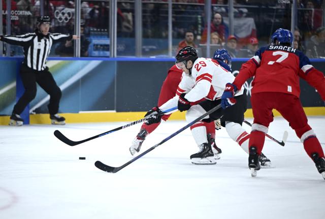 (260212) -- MILAN, Feb. 12, 2026 (Xinhua) -- Nathan MacKinnon (C) of Canada breaks through during the ice hockey men's preliminary round group A match between Canada and the Czech Republic at the Milan-Cortina 2026 Olympic Winter Games in Milan, Italy, Feb. 12, 2026. (Xinhua/Zhang Haofu)