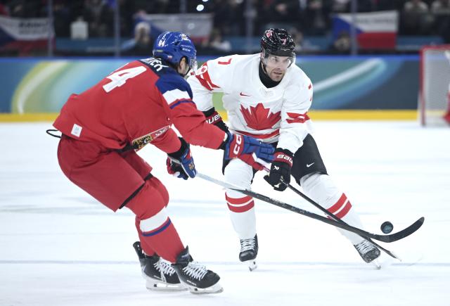 (260212) -- MILAN, Feb. 12, 2026 (Xinhua) -- Devon Toews (R) of Canada vies with Tomas Kundratek of the Czech Republic during the ice hockey men's preliminary round group A match between Canada and the Czech Republic at the Milan-Cortina 2026 Olympic Winter Games in Milan, Italy, Feb. 12, 2026. (Xinhua/Zhang Haofu)