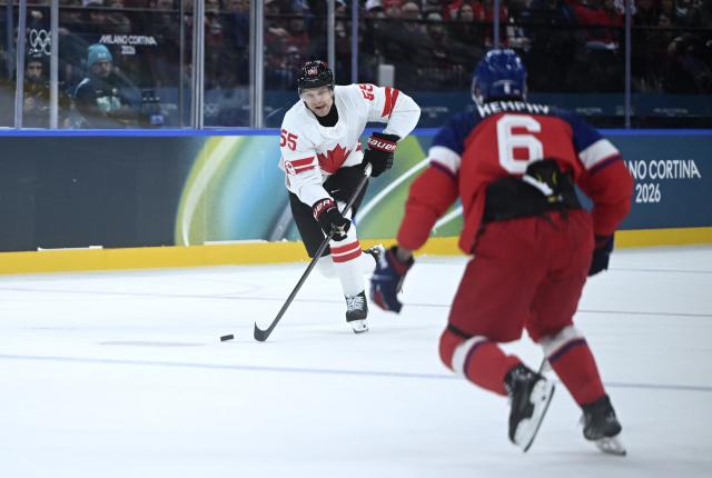 (260212) -- MILAN, Feb. 12, 2026 (Xinhua) -- Colton Parayko (L) of Canada breaks through during the ice hockey men's preliminary round group A match between Canada and the Czech Republic at the Milan-Cortina 2026 Olympic Winter Games in Milan, Italy, Feb. 12, 2026. (Xinhua/Zhang Haofu)