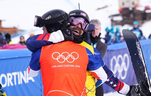 (260212) -- LIVIGNO, Feb. 12, 2026 (Xinhua) -- Nick Baumgartner (R) of the United States hugs with Jonas Chollet of France after the snowboard men's cross small final at the Milan-Cortina 2026 Olympic Winter Games in Livigno, Italy, Feb. 12, 2026. (Xinhua/Wu Huiwo)