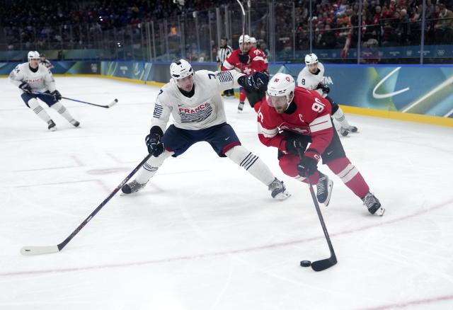 (260212) -- MILAN, Feb. 12, 2026 (Xinhua) -- Roman Josi (R) of Switzerland competes during the ice hockey men's preliminary round group A match between Switzerland and France at the Milan-Cortina 2026 Olympic Winter Games in Milan, Italy, Feb. 12, 2026. (Xinhua/Tao Xiyi)