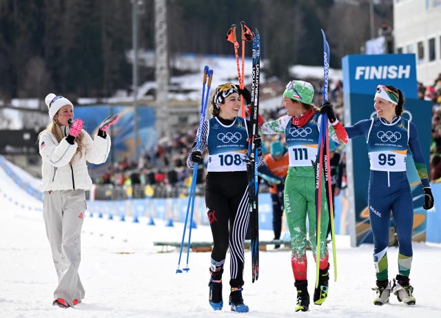 (260212) -- TESERO, Feb. 12, 2026 (Xinhua) -- Samaneh Beyrami Baher (2nd R) of Iran interacts with Jessie Diggins (1st L) of the United States after the cross-country skiing women's 10km interval start free match at the Milan-Cortina 2026 Olympic Winter Games in Tesero, Italy, Feb. 12, 2026. (Xinhua/He Canling)