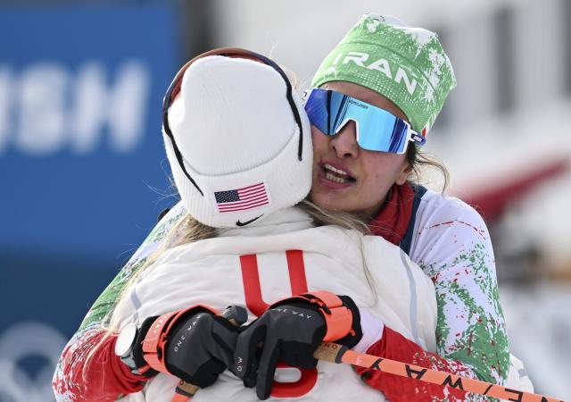 (260212) -- TESERO, Feb. 12, 2026 (Xinhua) -- Samaneh Beyrami Baher (R) of Iran hugs Jessie Diggins of the United States after the cross-country skiing women's 10km interval start free match at the Milan-Cortina 2026 Olympic Winter Games in Tesero, Italy, Feb. 12, 2026. (Xinhua/He Canling)