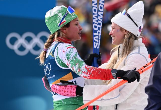 (260212) -- TESERO, Feb. 12, 2026 (Xinhua) -- Samaneh Beyrami Baher (L) of Iran interacts with Jessie Diggins of the United States after the cross-country skiing women's 10km interval start free match at the Milan-Cortina 2026 Olympic Winter Games in Tesero, Italy, Feb. 12, 2026. (Xinhua/He Canling)