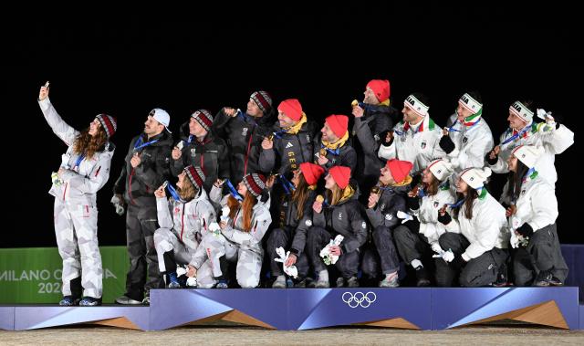 (260212) -- CORTINA D'AMPEZZO, Feb. 12, 2026 (Xinhua) -- Gold medalists from team Germany (C), silver medalists from team Austria (L) and bronze medalists from team Italy take a selfie during the awarding ceremony of the luge team relay match at the Milan-Cortina 2026 Olympic Winter Games in Cortina, Italy, Feb. 12, 2026. (Xinhua/Lian Yi)