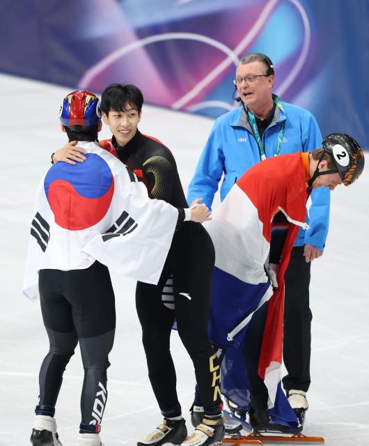 (260212) -- MILAN, Feb. 12, 2026 (Xinhua) -- Silver medalist Sun Long (2nd L) of China hugs bronze medalist Rim Jongun of South Korea (1st L) after the short track speed skating men's 1000m final A at the Milan-Cortina 2026 Olympic Winter Games in Milan, Italy, Feb. 12, 2026. (Xinhua/Li Ming)