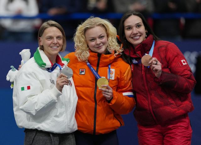 (260212) -- MILAN, Feb. 12, 2026 (Xinhua) -- Gold medalist Xandra Velzeboer (C) of the Netherlands, silver medalist Arianna Fontana (L) of Italy, and Courtney Sarault of Canada pose for photos during the awarding ceremony of the short track speed skating women's 500m at the Milan-Cortina 2026 Olympic Winter Games in Milan, Italy, Feb. 12, 2026. (Xinhua/Xue Yuge)