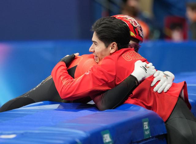 (260212) -- MILAN, Feb. 12, 2026 (Xinhua) -- Sun Long (L) of China celebrates with his teammate Liu Shaoang after the short track speed skating men's 1000m final A at the Milan-Cortina 2026 Olympic Winter Games in Milan, Italy, Feb. 12, 2026. (Xinhua/Xue Yuge)
