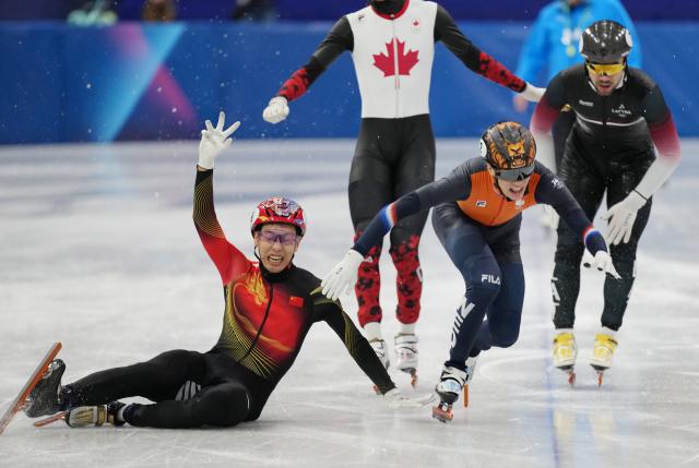 (260212) -- MILAN, Feb. 12, 2026 (Xinhua) -- Sun Long (1st L) of China falls over after crossing the finish line during the short track speed skating men's 1000m final A at the Milan-Cortina 2026 Olympic Winter Games in Milan, Italy, Feb. 12, 2026. (Xinhua/Xue Yuge)