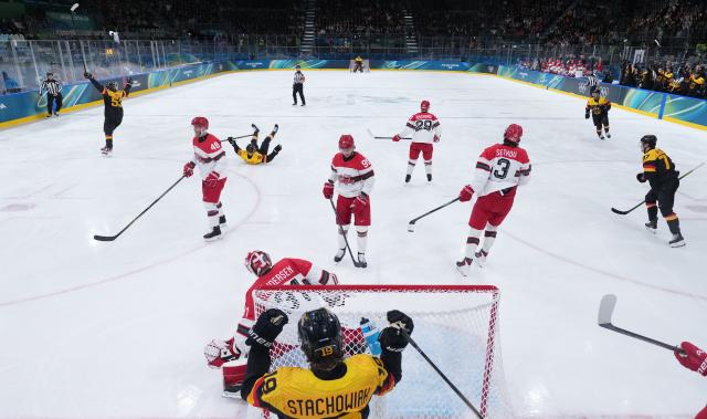 (260213) -- MILAN, Feb. 13, 2026 (Xinhua) -- Players of Germany celebrate a goal during the ice hockey men's preliminary round group C match between Denmark and Germany at the Milan-Cortina 2026 Olympic Winter Games in Milan, Italy, Feb. 12, 2026. (Wang Kaiyan/Pool via Xinhua)
