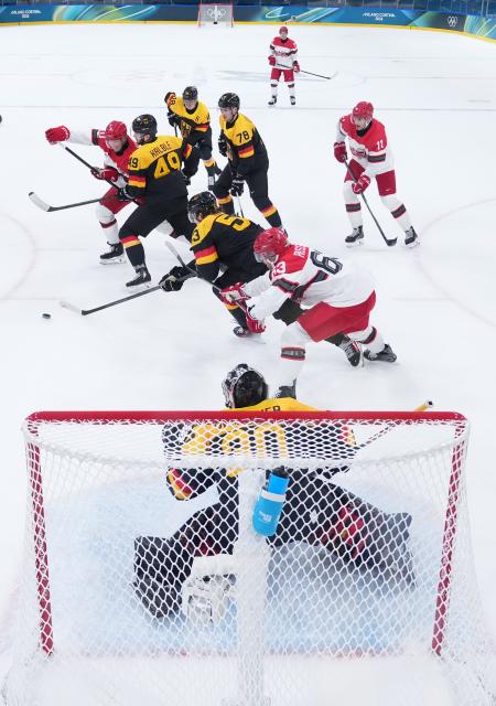 (260213) -- MILAN, Feb. 13, 2026 (Xinhua) -- Players of both teams compete during the ice hockey men's preliminary round group C match between Denmark and Germany at the Milan-Cortina 2026 Olympic Winter Games in Milan, Italy, Feb. 12, 2026. (Wang Kaiyan/Pool via Xinhua)