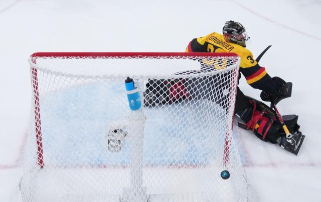 (260213) -- MILAN, Feb. 13, 2026 (Xinhua) -- Philip Grubauer, goalkeeper of Germany makes a save during the ice hockey men's preliminary round group C match between Denmark and Germany at the Milan-Cortina 2026 Olympic Winter Games in Milan, Italy, Feb. 12, 2026. (Wang Kaiyan/Pool via Xinhua)