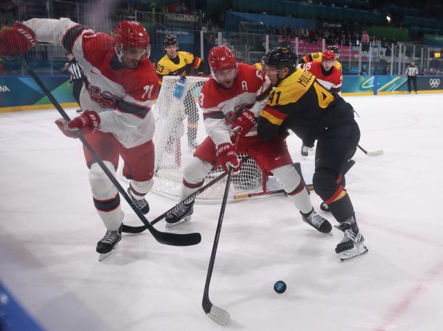 (260213) -- MILAN, Feb. 13, 2026 (Xinhua) -- Jonas Muller (R in front) of Germany play defense during the ice hockey men's preliminary round group C match between Denmark and Germany at the Milan-Cortina 2026 Olympic Winter Games in Milan, Italy, Feb. 12, 2026. (Xinhua/Wang Kaiyan)