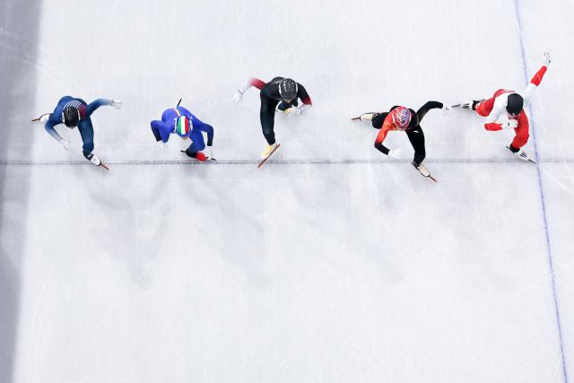 (260213) -- MILAN, Feb. 13, 2026 (Xinhua) -- Sun Long (2nd R) of China competes during the short track speed skating men's 1000m quarterfinal at the Milan-Cortina 2026 Olympic Winter Games in Milan, Italy, Feb. 12, 2026. (Xinhua/Chen Yichen)