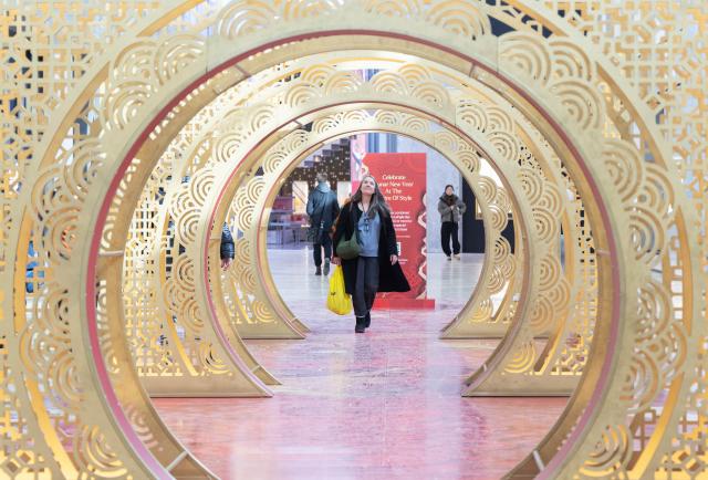 (260213) -- TORONTO, Feb. 13, 2026 (Xinhua) -- A woman walks through a Chinese New Year art installation at a shopping center in Toronto, Canada, Feb. 12, 2026.
  Major shopping centers in Toronto have recently unveiled new decorations to celebrate the upcoming Chinese New Year, which falls on Feb. 17, marking the beginning of the Year of the Horse. (Photo by Zou Zheng/Xinhua)